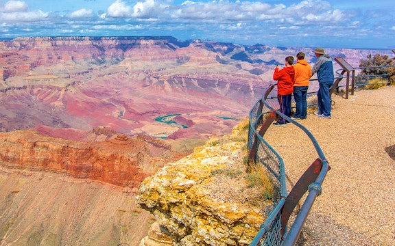 Visitors enjoying the view from a Grand Canyon overlook, Arizona.