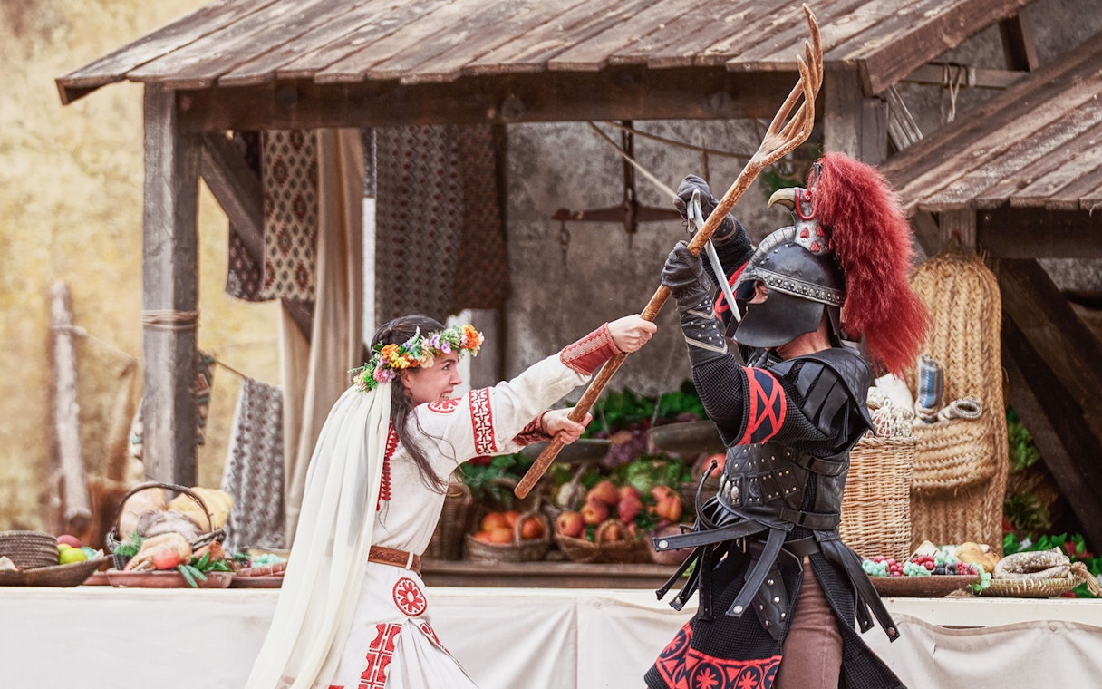 Medieval reenactment at Puy du Fou España with actors in historical costumes.