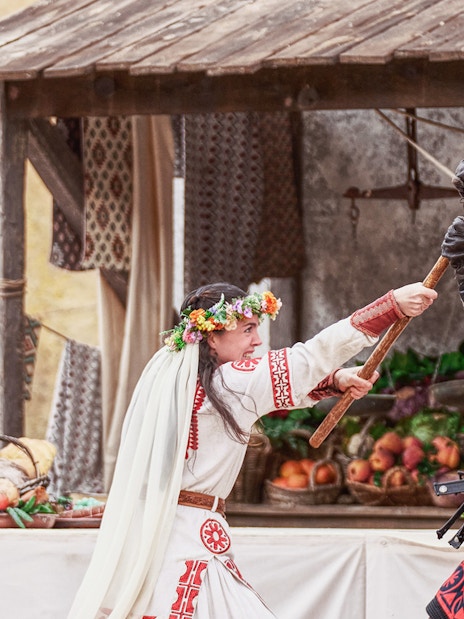 Medieval reenactment at Puy du Fou España with actors in historical costumes.