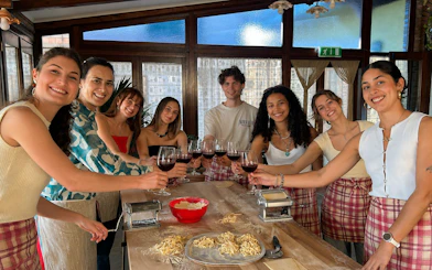 Group enjoying pasta making class with wine at Amalfi Coast farmhouse.