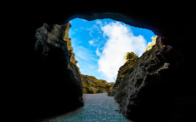 Hercules Cave entrance with rocky walls and blue sky in Tangier, Morocco.