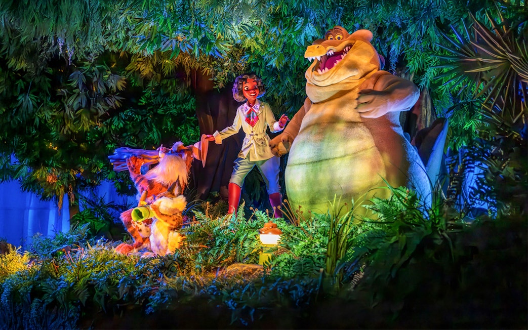 Tiana and friends in a vibrant bayou scene at night, Walt Disney World Resort, Orlando.
