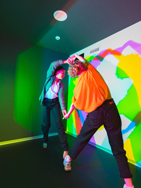 Visitors interacting with colorful light display at Paradox Museum, Stockholm.