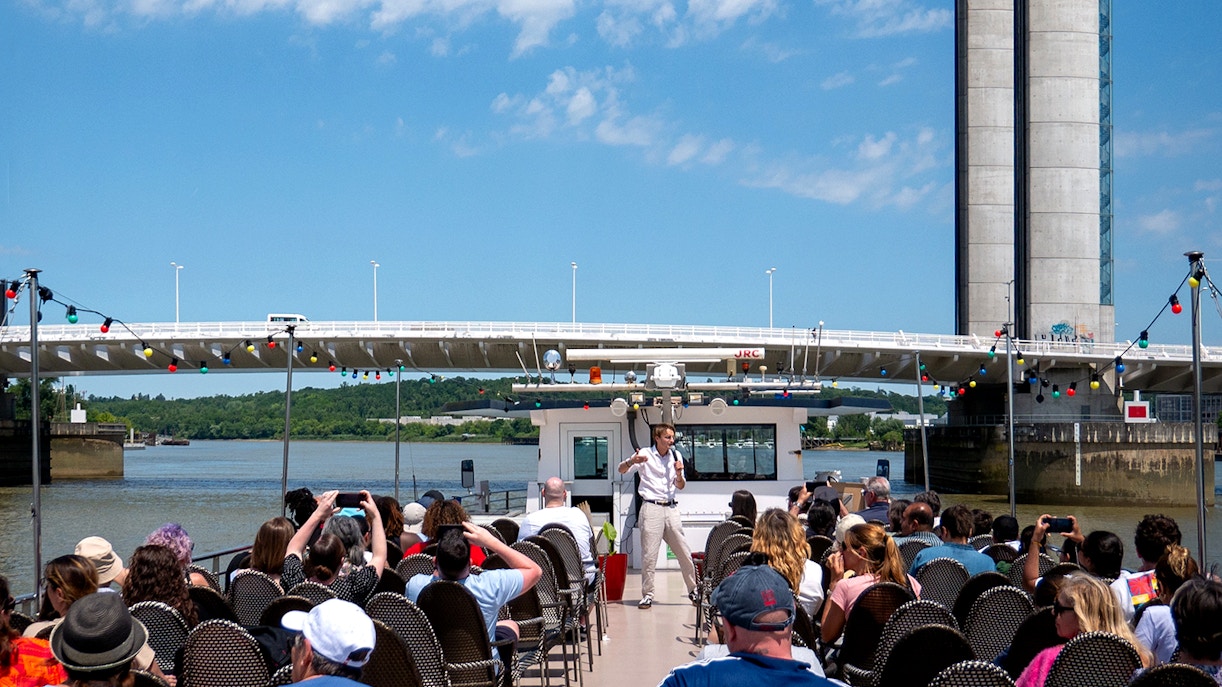 A guide on board doing live commentary during Bordeaux Sightseeing River Cruise