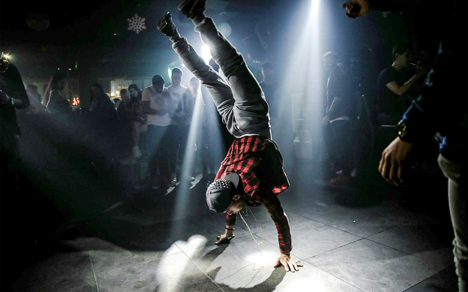 Breakdancer performing handstand at 2024 Paris Olympics event.
