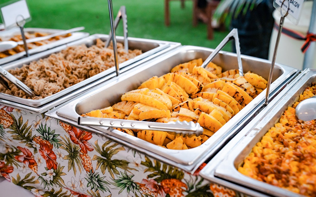 Buffet with grilled pineapple and pulled pork at Mauka Warriors Luau.