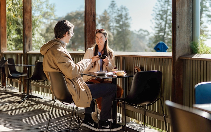 Couple enjoying coffee at a cafe on Churchill Island.