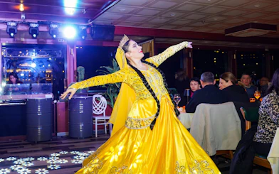 Performer in traditional attire dancing on Luxury Bosphorus Dinner Cruise.