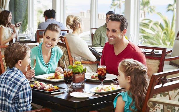 Family dining at a restaurant in Dubai, enjoying a meal together.