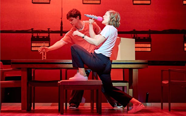 Actors performing a scene in "Inter Alia" with dynamic expressions and gestures.