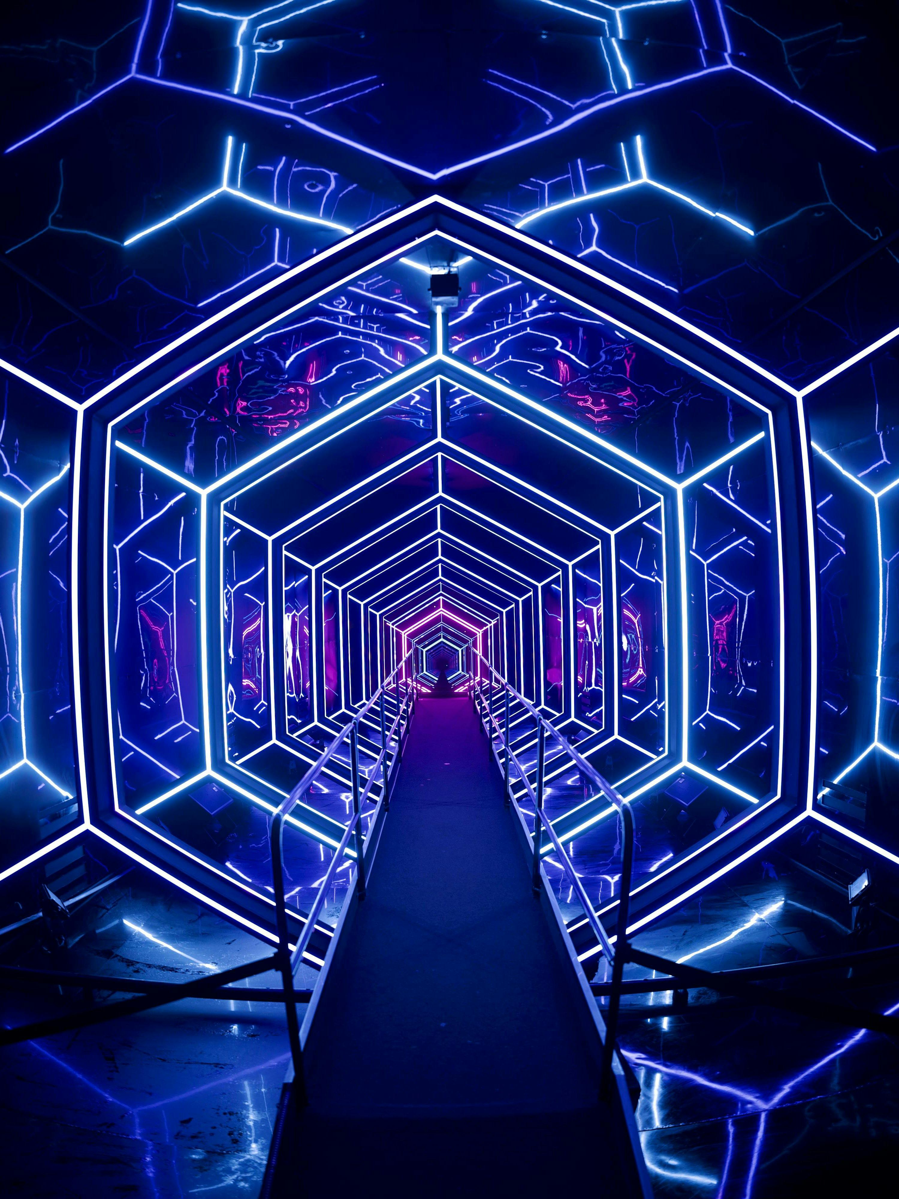 Futuristic neon-lit tunnel at AMAZE Amsterdam experience.