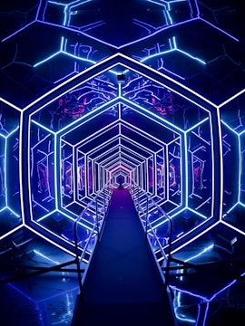 Futuristic neon-lit tunnel at AMAZE Amsterdam experience.