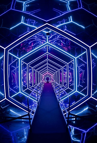 Futuristic neon-lit tunnel at AMAZE Amsterdam experience.