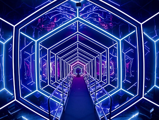 Futuristic neon-lit tunnel at AMAZE Amsterdam experience.