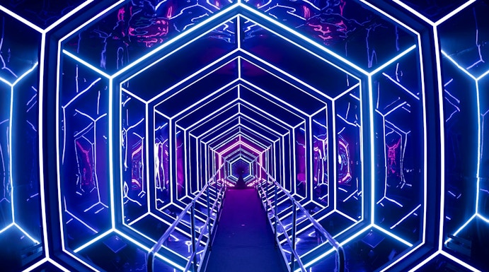 Futuristic neon-lit tunnel at AMAZE Amsterdam experience.