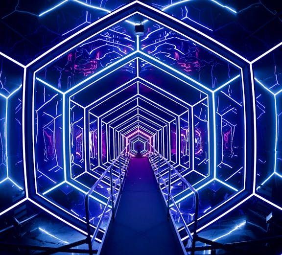 Futuristic neon-lit tunnel at AMAZE Amsterdam experience.