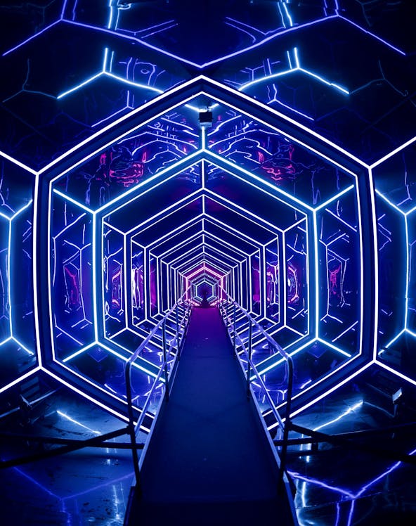 Futuristic neon-lit tunnel at AMAZE Amsterdam experience.