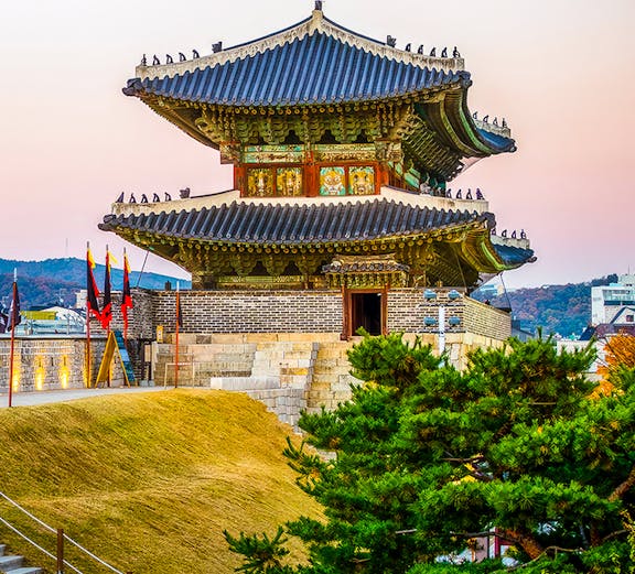 Suwon Hwaseong fortress gate at sunset, South Korea.