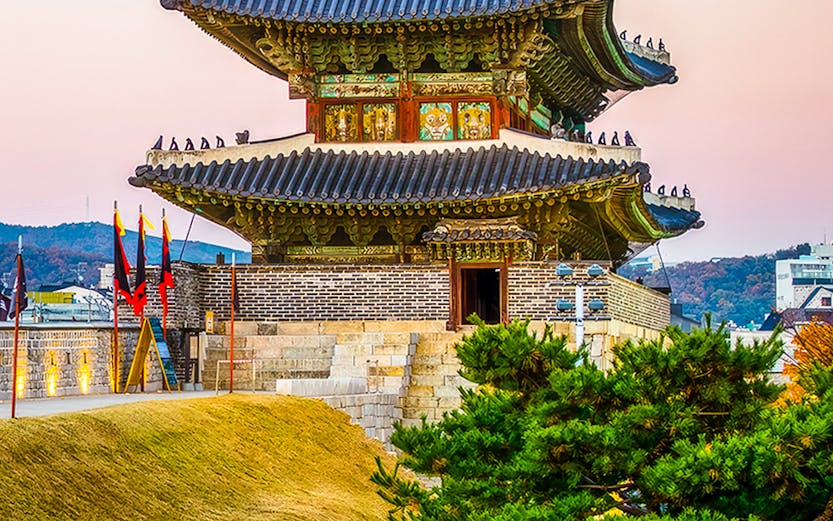 Suwon Hwaseong fortress gate at sunset, South Korea.
