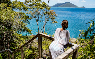 Visitor overlooking ocean view from Fitzroy Island trail.