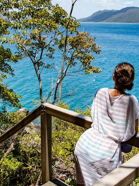 Visitor overlooking ocean view from Fitzroy Island trail.