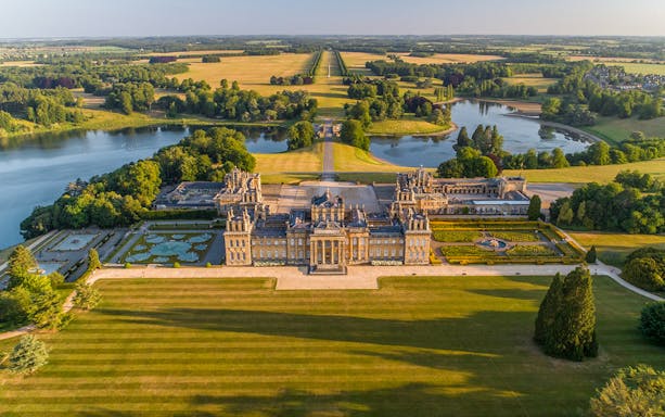 Aerial view of Blenheim Palace with formal gardens and parkland in Oxfordshire, England.