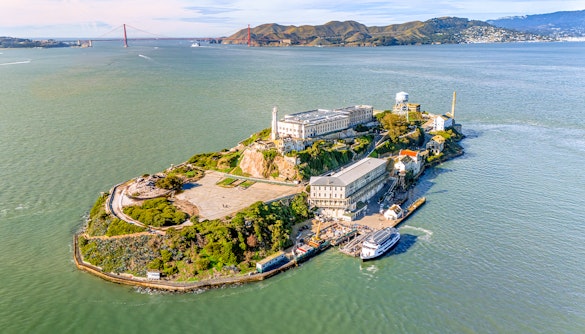Aerial view of Alcatraz Island with ferry approaching in San Francisco Bay, USA.