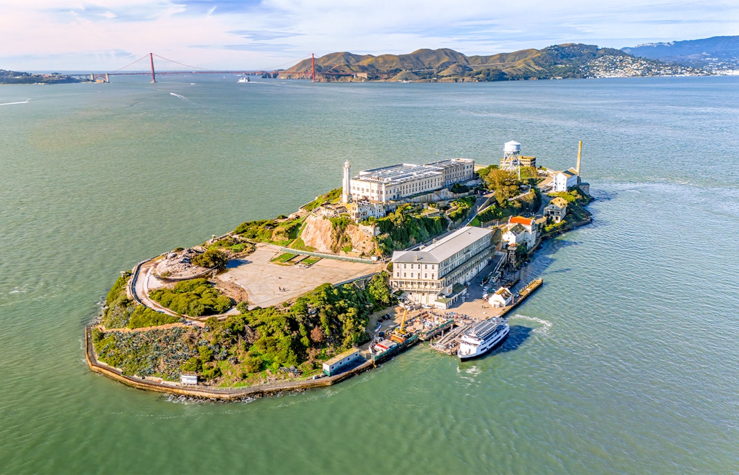 Aerial view of Alcatraz Island with ferry approaching in San Francisco Bay, USA.