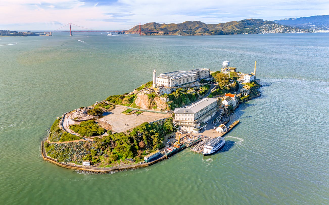 Aerial view of Alcatraz Island with ferry approaching in San Francisco Bay, USA.