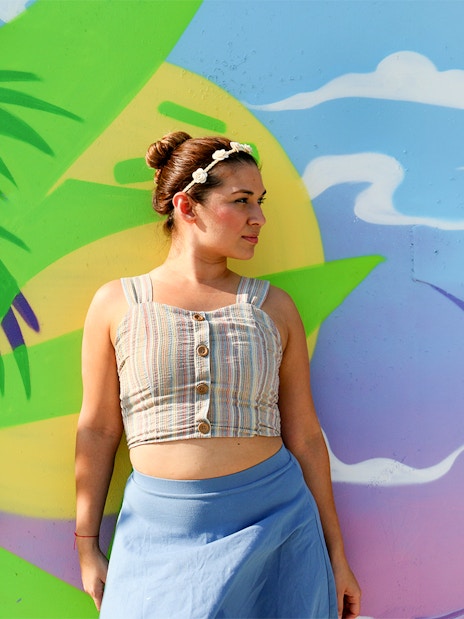 Woman standing in front of colorful mural at Wynwood Walls, Miami, Florida.