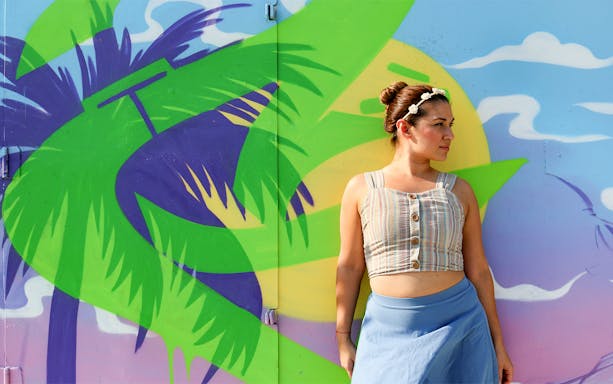 Woman standing in front of colorful mural at Wynwood Walls, Miami, Florida.
