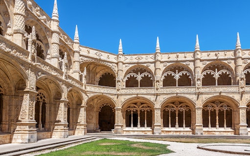 Monastery of Jeronimos Cloister entrance with ornate arches, Lisbon, Portugal.
