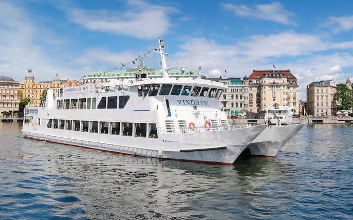 Stockholm archipelago tour boat near city waterfront.