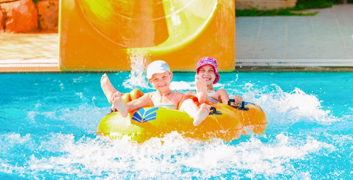 Guests on a water slide raft at Aquapark Wroclaw.