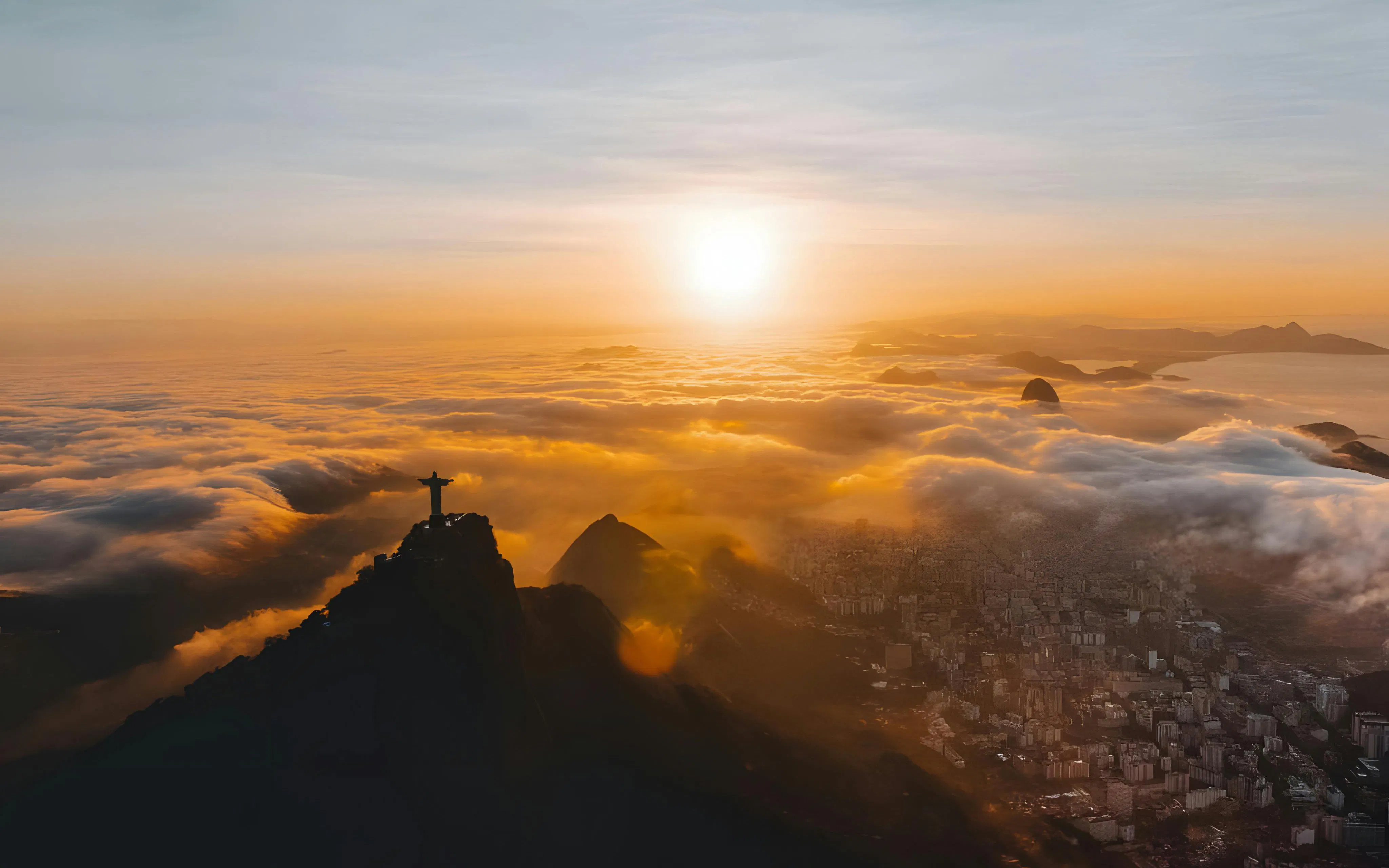 Sunset view of Christ the Redeemer from a helicopter tour in Rio de Janeiro.