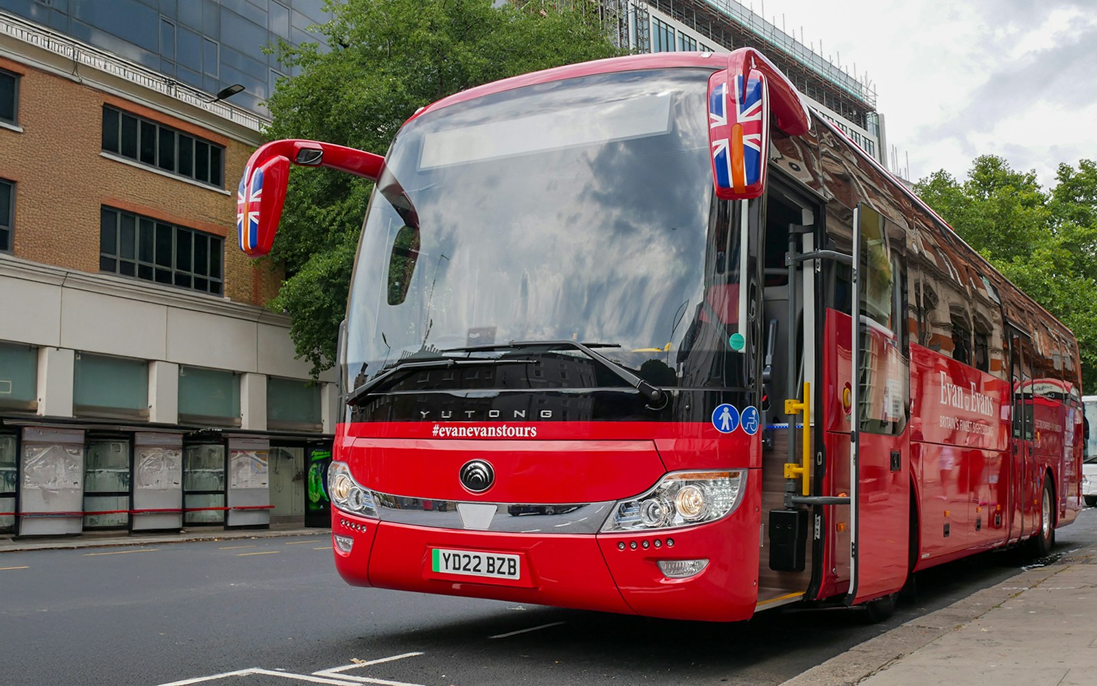 Stonehenge, Windsor Castle, and Bath day trip coach parked near London street.