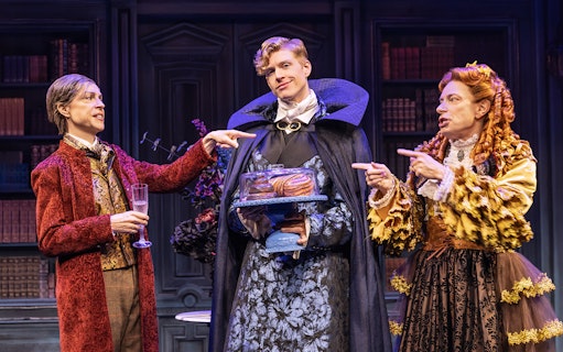 Actors in period costumes performing a scene from "Dracula, A Comedy of Terrors" on stage.