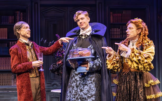 Actors in period costumes performing a scene from "Dracula, A Comedy of Terrors" on stage.