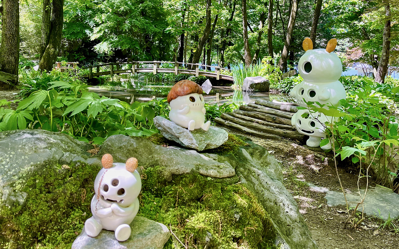 Ceramic figures among bamboo groves and a wooden bridge in Nami Island, South Korea.