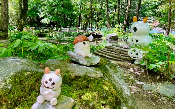 Ceramic figures among bamboo groves and a wooden bridge in Nami Island, South Korea.