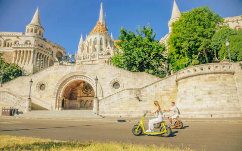 Fisherman's Bastion with e-scooter riders, Budapest Grand Highlights Tour.