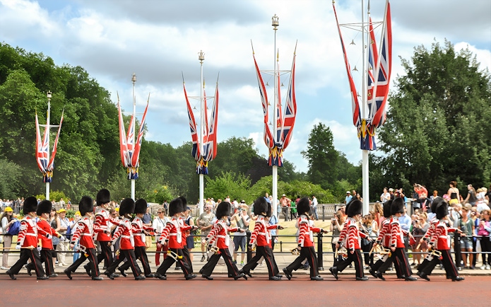Guards marching in London with Union Jack flags, part of the Magic of London Tour.