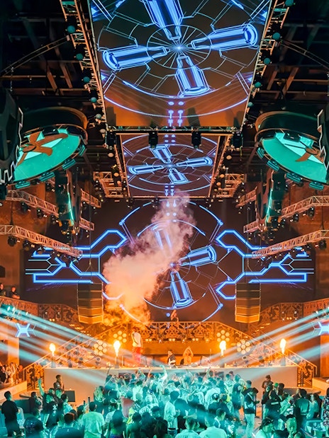 Tourists at CKay Event, Atlas Beach Club Bali, enjoying live music and beachfront views.