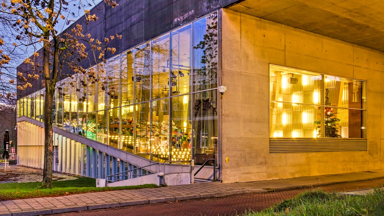Kunsthal museum exterior with illuminated glass facade in Rotterdam.