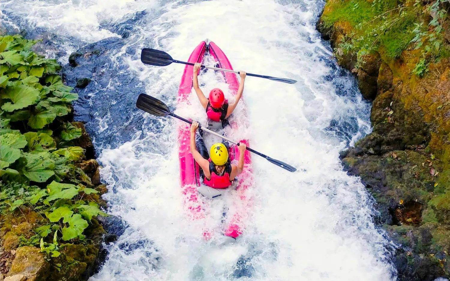 Tourists kayaking through Mrežnica Canyon waterfalls near Split.