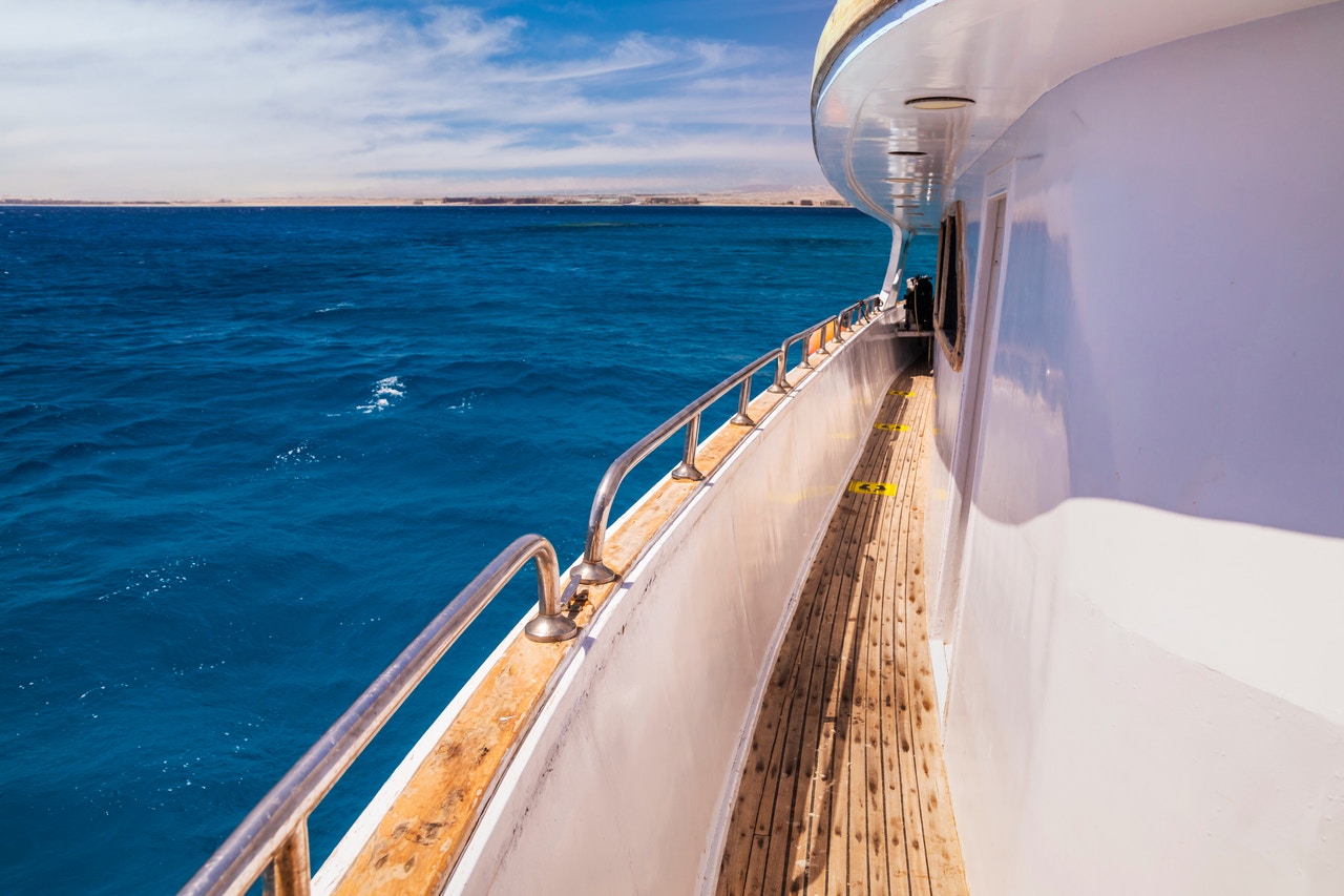 Luxury yacht sailing on clear blue water, Red Sea, Hurghada dolphin tour.