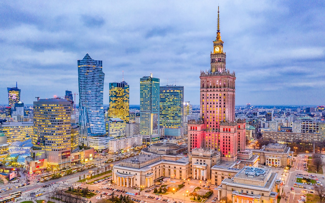 Warsaw skyline with Palace of Culture and Science at dusk.