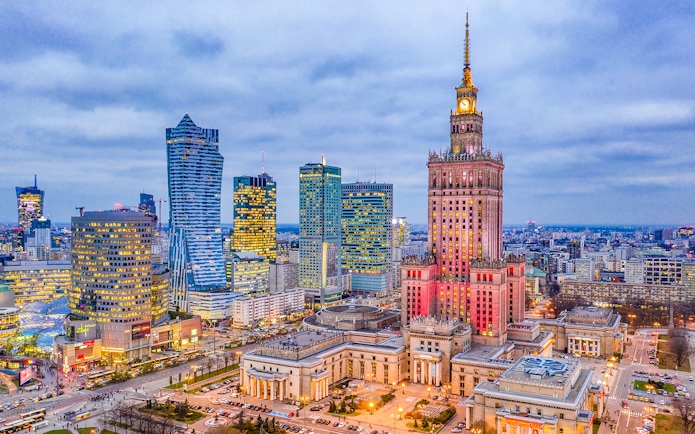 Warsaw skyline with Palace of Culture and Science at dusk.