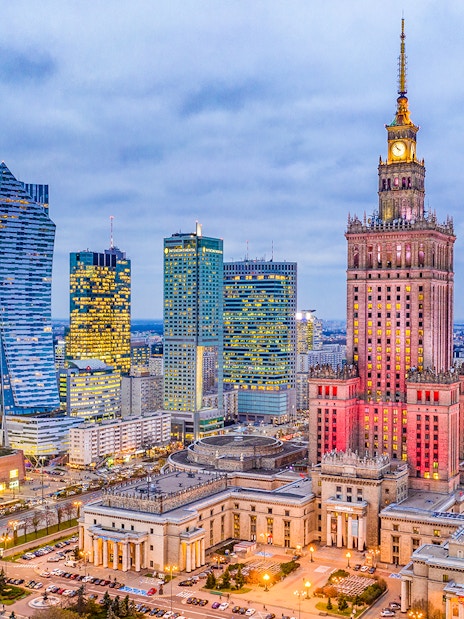Warsaw skyline with Palace of Culture and Science at dusk.