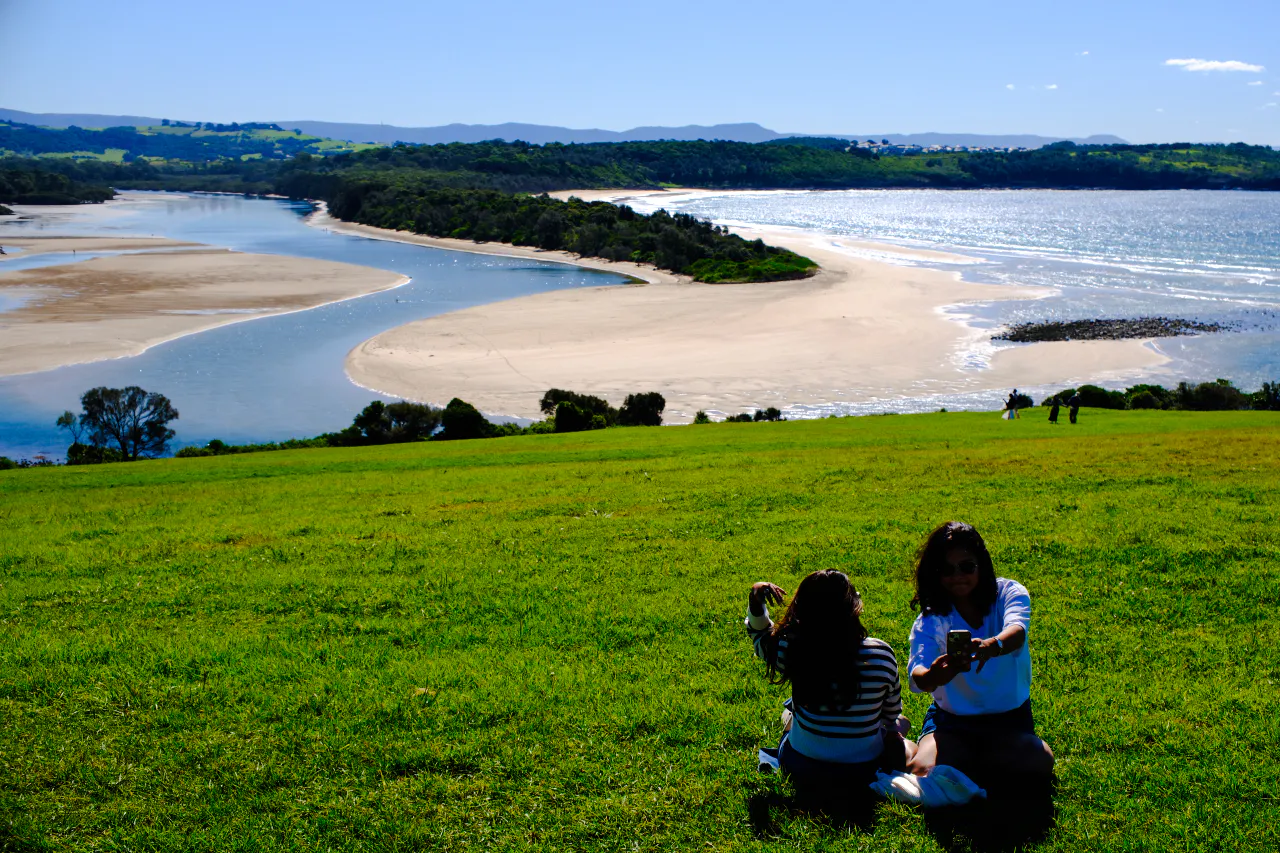 Visitors enjoying a scenic view of the coastline near Kiama Blowhole, Sydney.